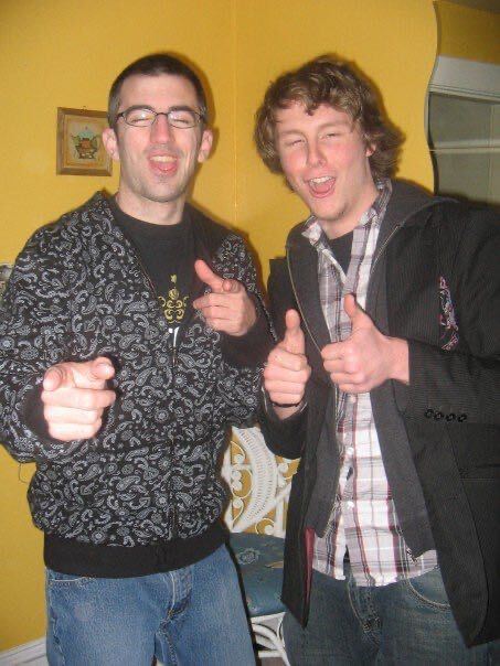Two blokes pointing at the camera